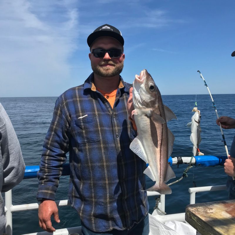 a man holding a fish in the water