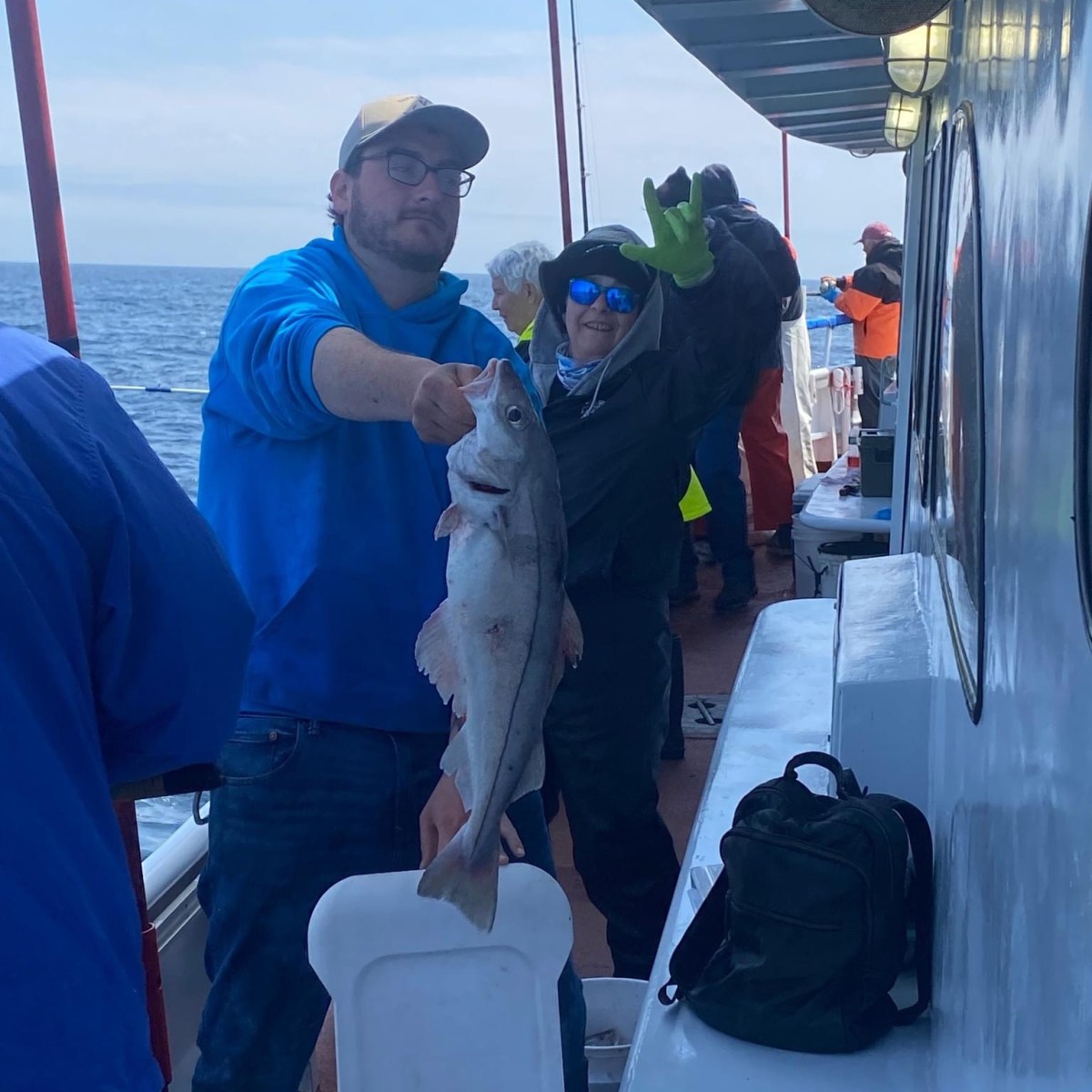 a person holding a fish on a boat