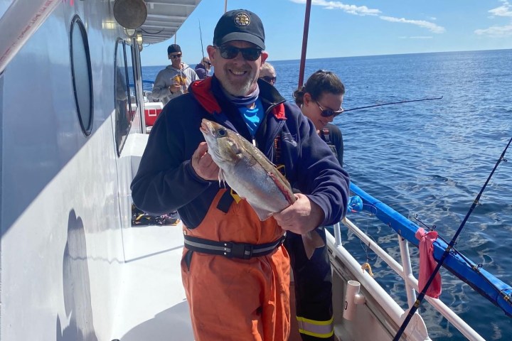 a man standing on a boat in the water