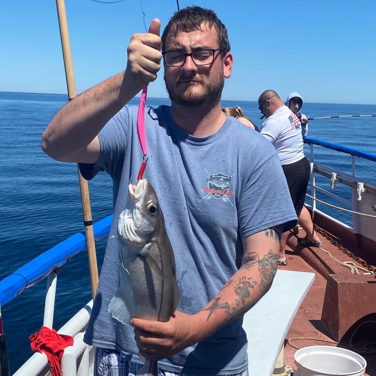 a man holding a fish in the water