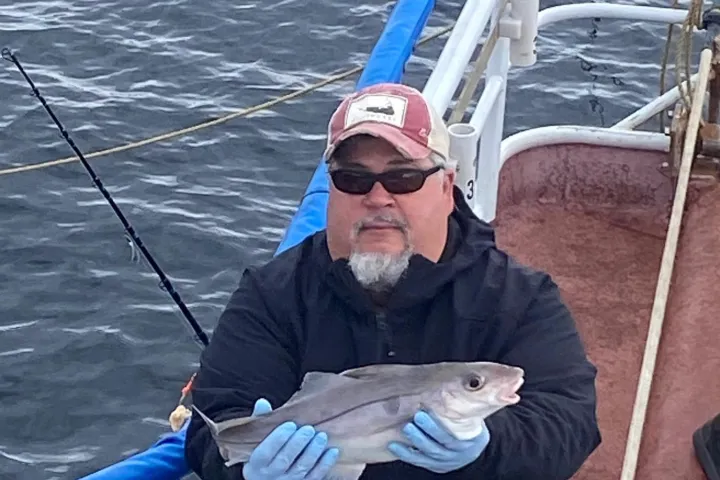 a person standing next to a body of water