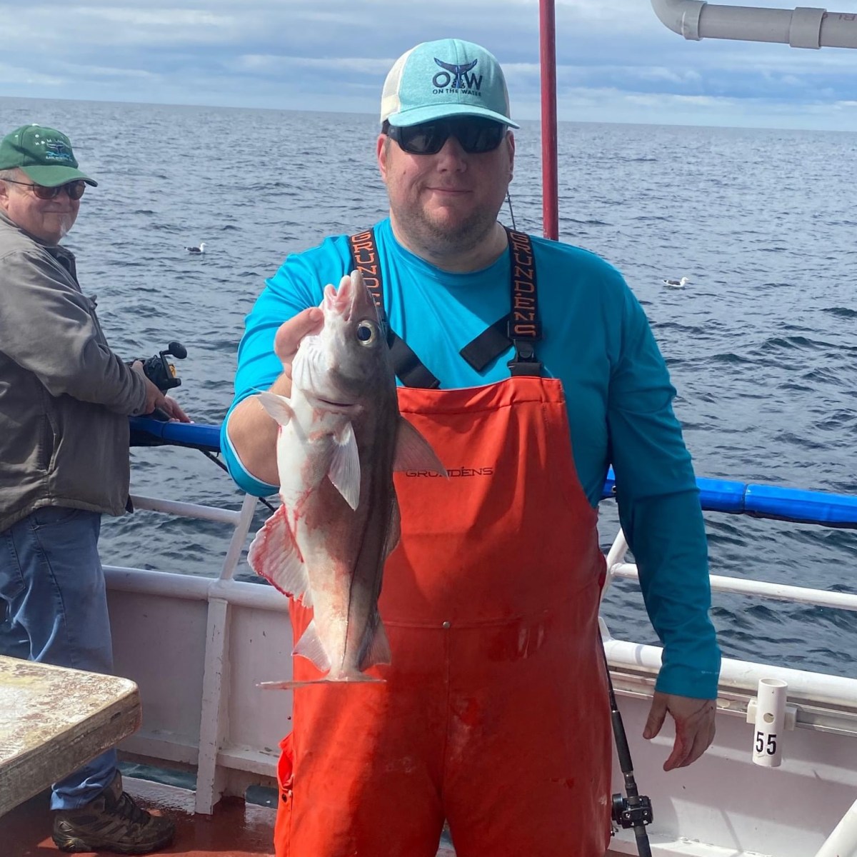 a man holding a fish in the water