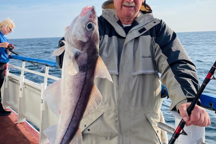 a person holding a fish in the water