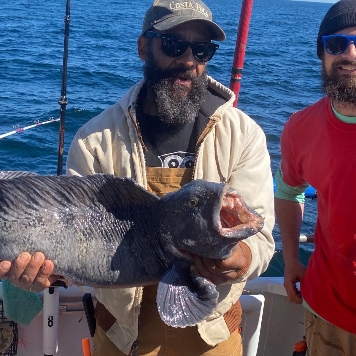 a man holding a fish in the water
