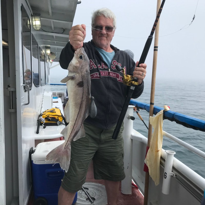 a man and a woman standing on a boat