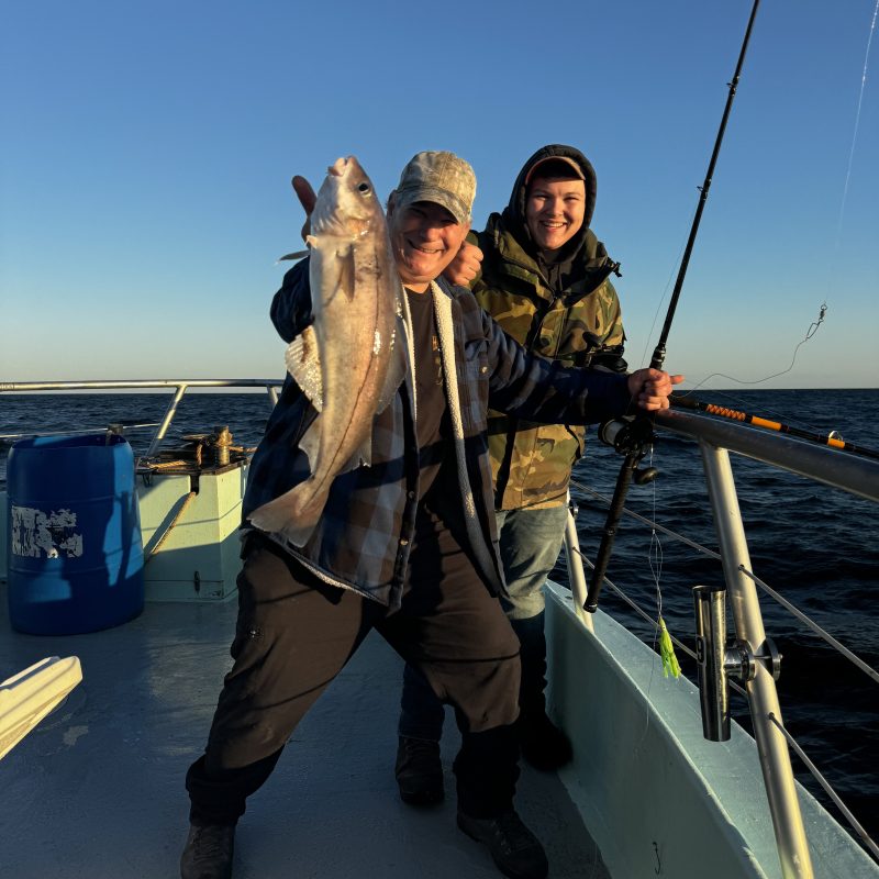 a person standing next to a body of water