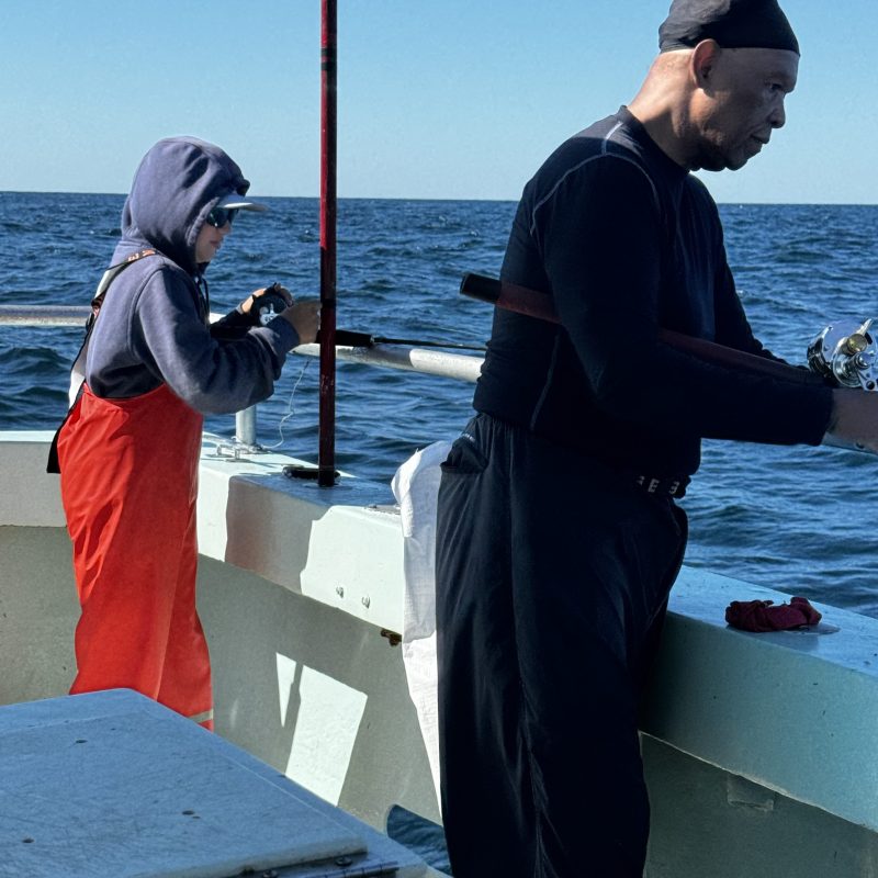 a person standing next to a body of water