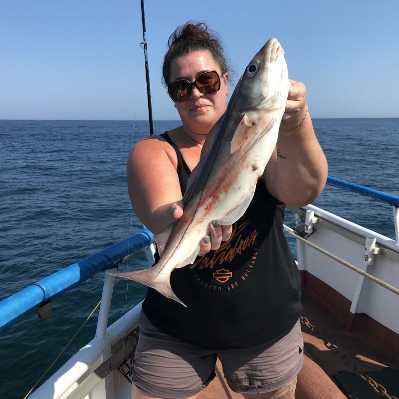 a person holding a fish in the water