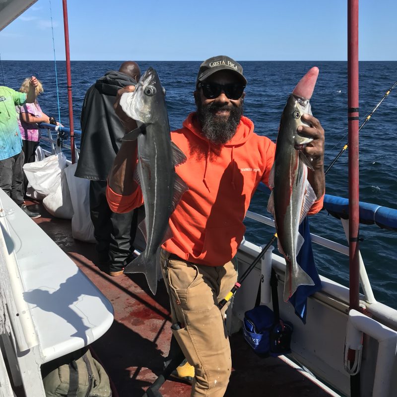 a group of people standing on a boat