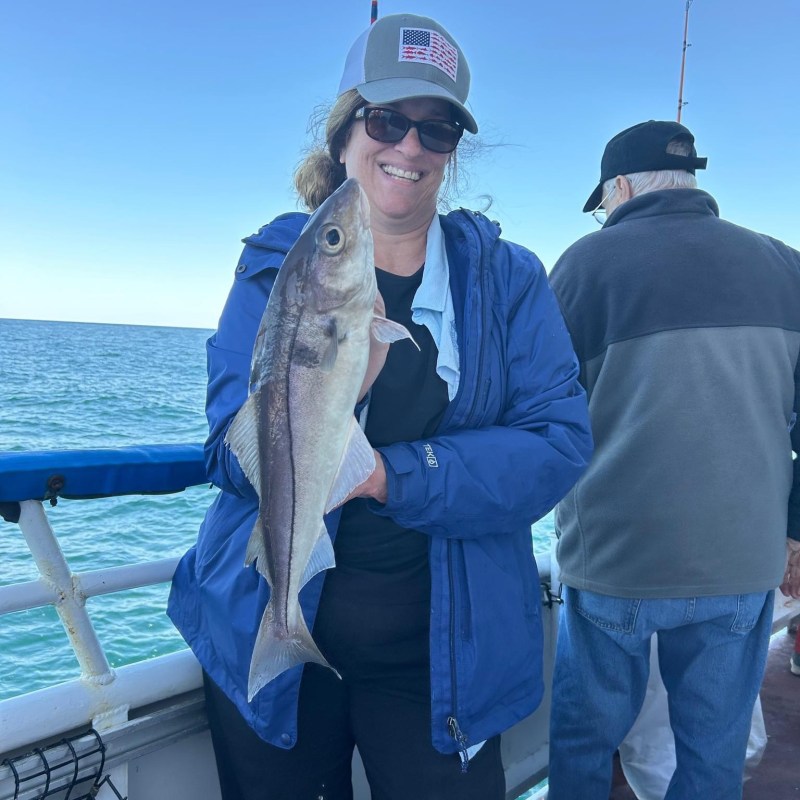 a person holding a fish in the water
