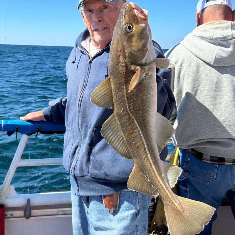 a person holding a fish in the water