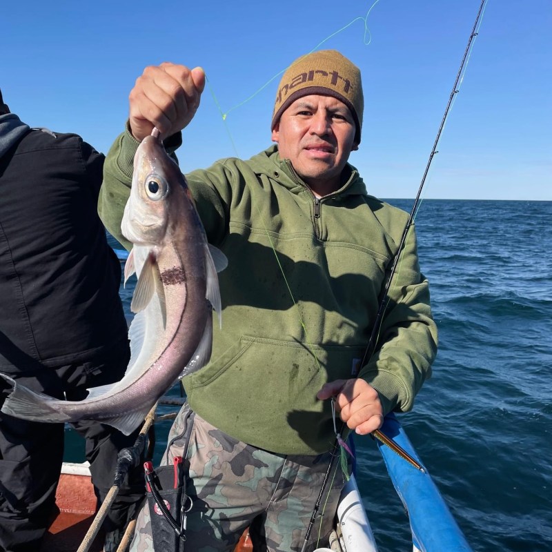 a person holding a fish in the water