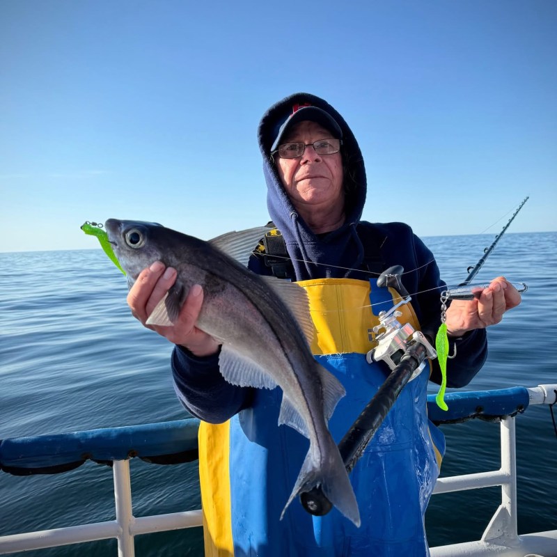 a person holding a fish in the water