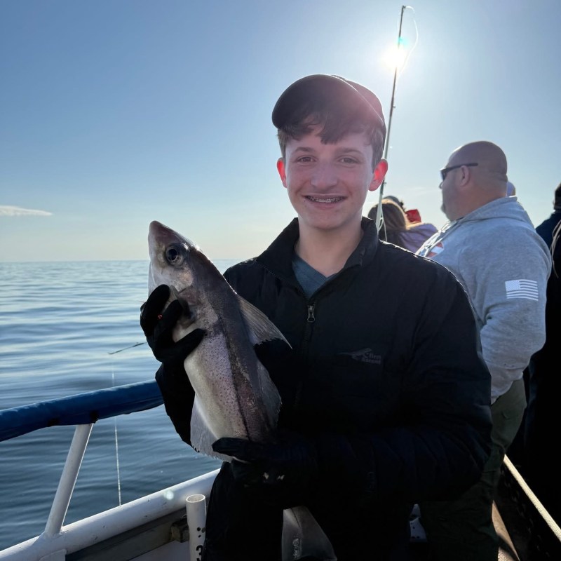 a person holding a fish in the water