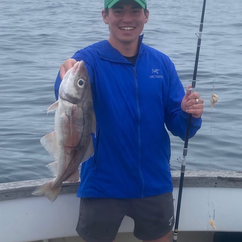 a man holding a fish in the water