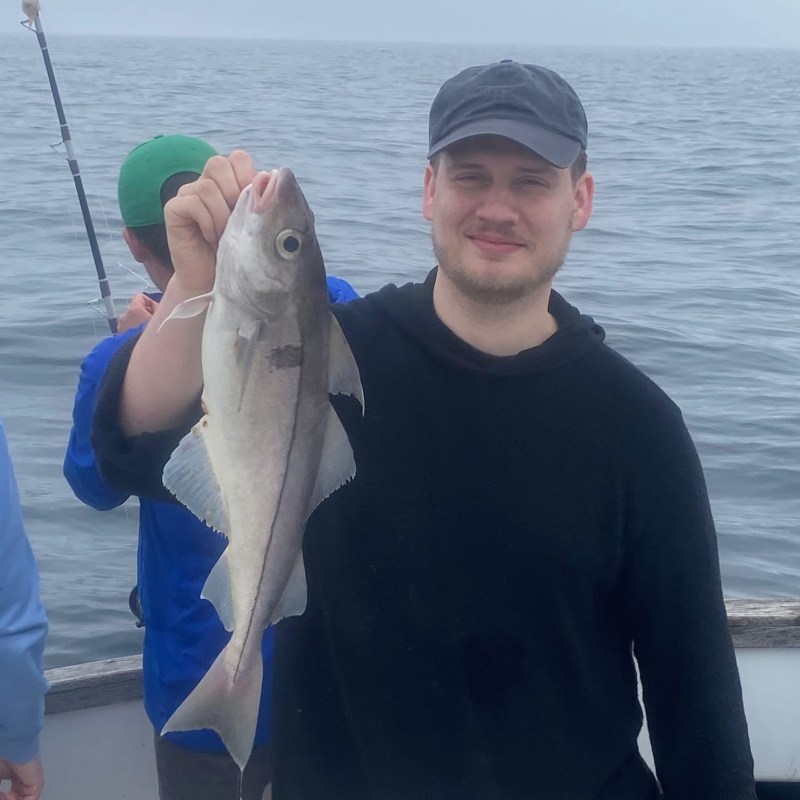 a person holding a fish in the water