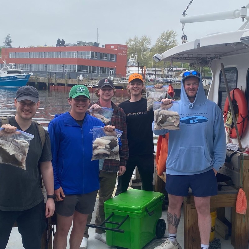 a group of people standing next to a train
