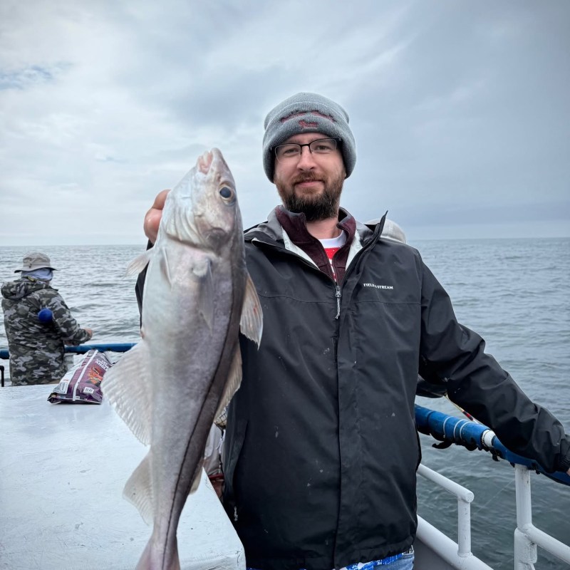a man holding a fish in the water