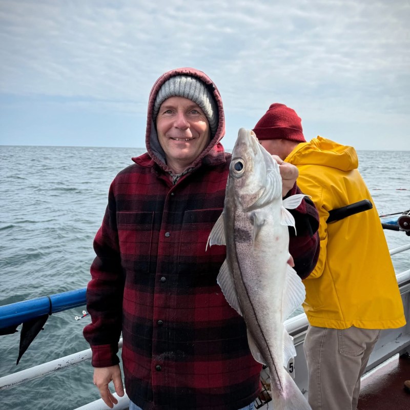 a person standing next to a body of water