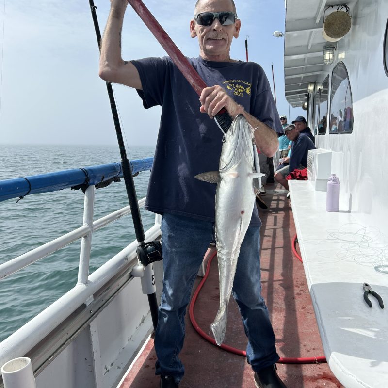 a person standing next to a boat