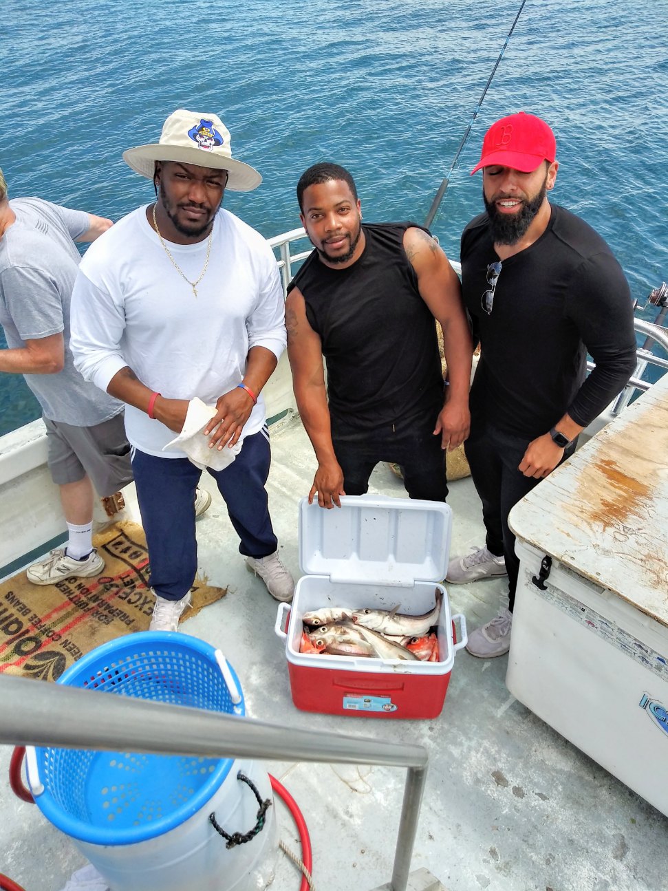 a group of people standing on top of a cutting board
