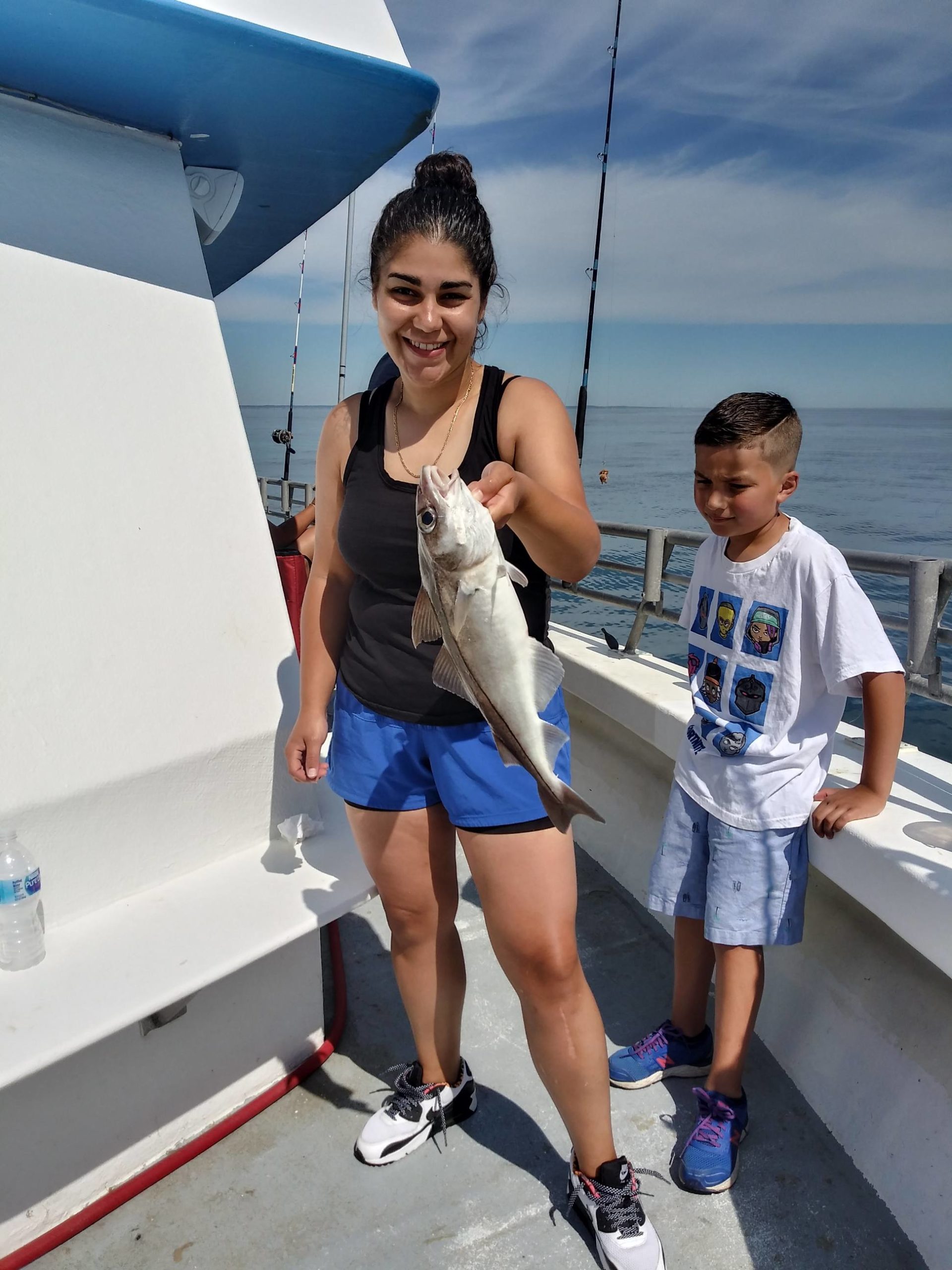 a young boy standing on a boat