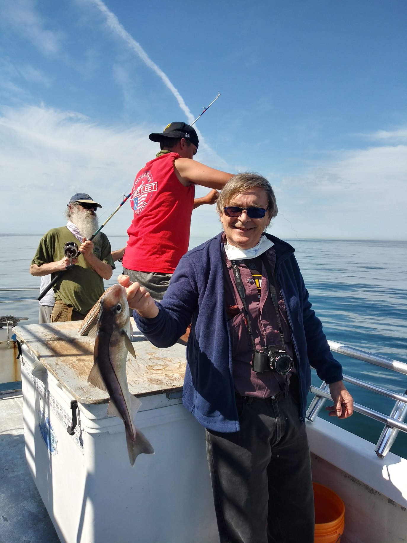 a man holding a fish in the water
