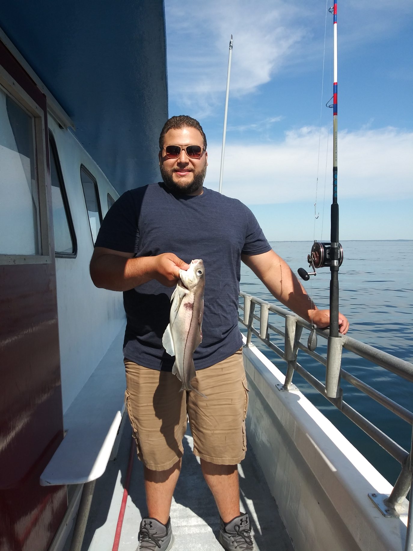 Brian Tomlinson standing on a boat in the water