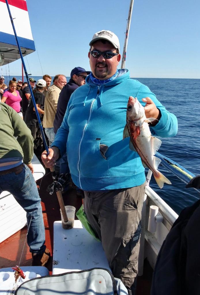 a group of people standing next to a body of water