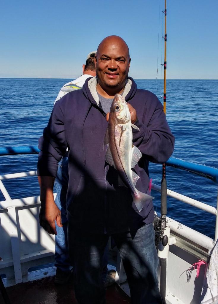 a man holding a fish in the water