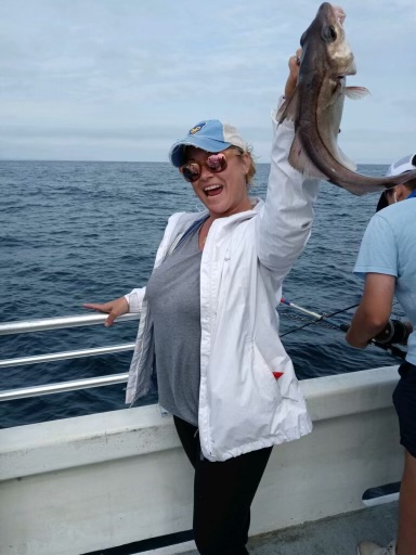a person standing next to a body of water