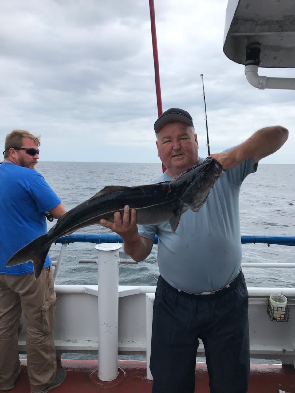 a man holding a fish in the water