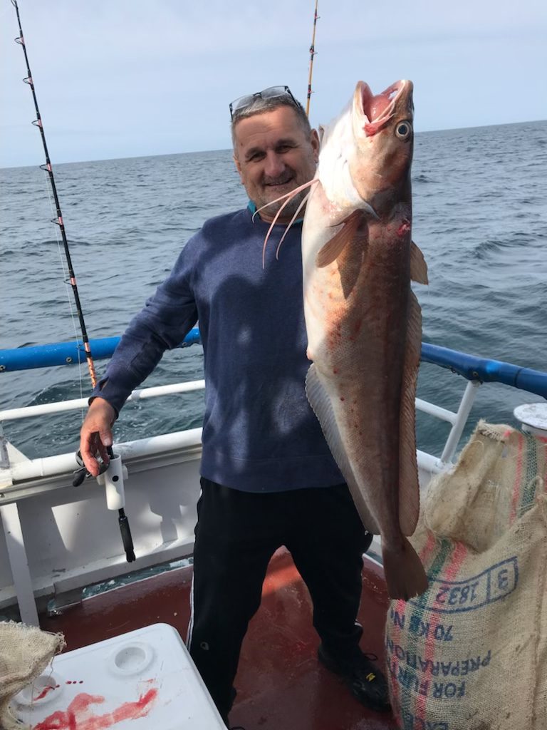 a person holding a fish in the water