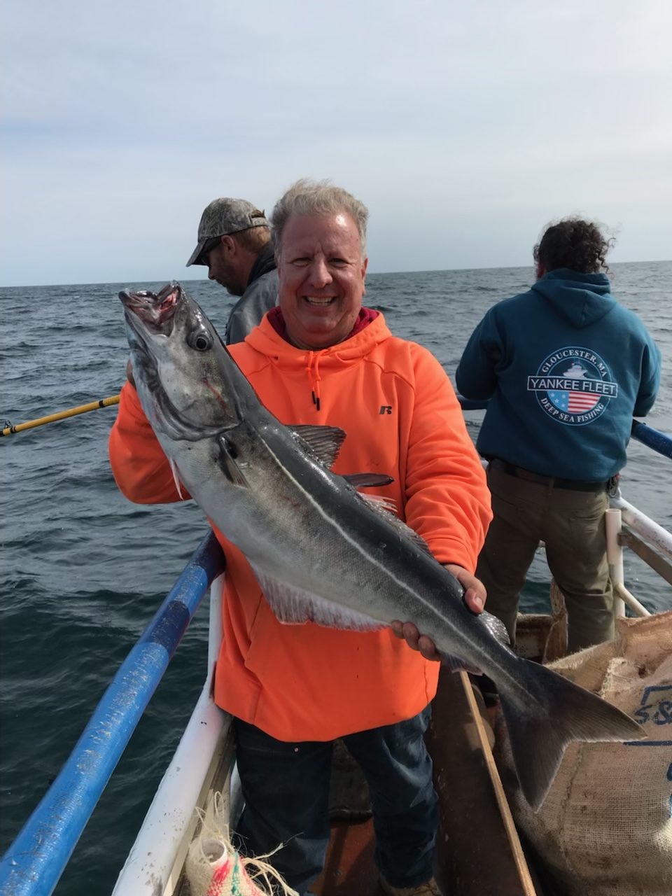 a man holding a fish in the water