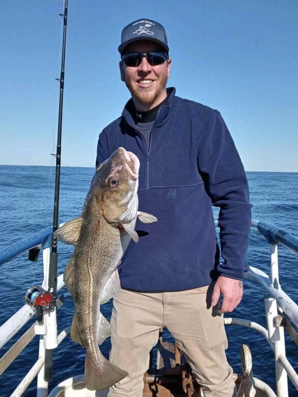 a man holding a fish in the water