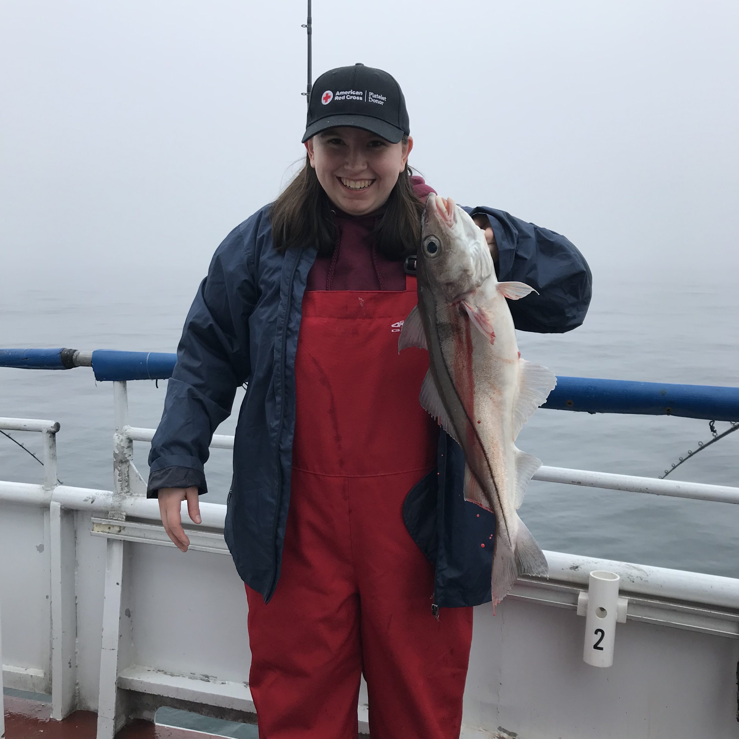 a person holding a fish on a boat